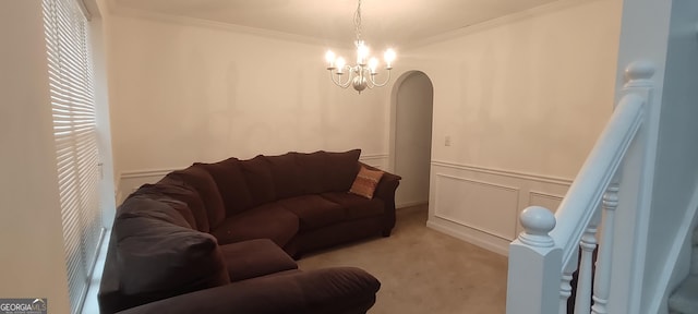 11950 Markham Way, Hampton, GA 30228 - living room featuring light colored carpet, ornamental molding, arched walkways, a chandelier, and wainscoting