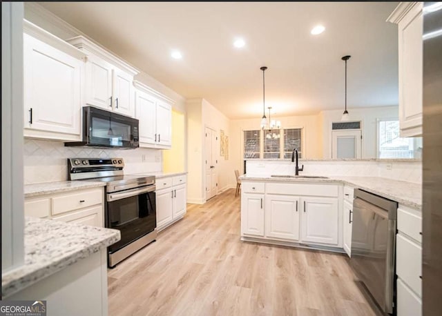 21 Whitegrass Way, Grayson, GA 30017 - kitchen with stainless steel appliances, a sink, white cabinetry, a chandelier, and decorative backsplash