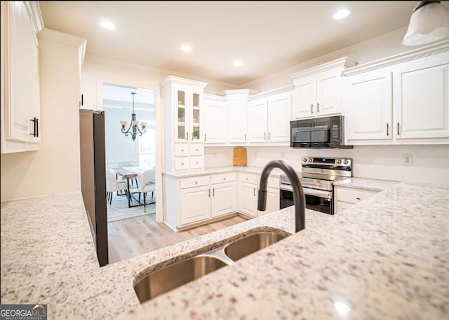 21 Whitegrass Way, Grayson, GA 30017 - kitchen featuring black microwave, stainless steel electric range oven, a sink, white cabinetry, and light stone counters