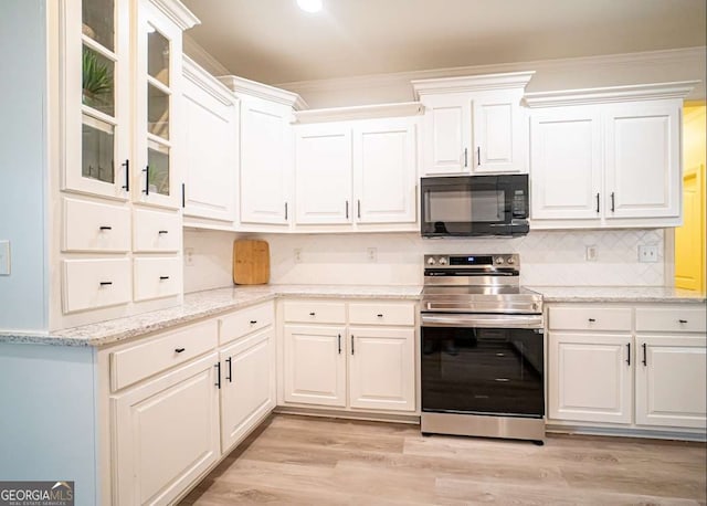 21 Whitegrass Way, Grayson, GA 30017 - kitchen featuring black microwave, stainless steel electric range, white cabinetry, light wood-style flooring, and crown molding