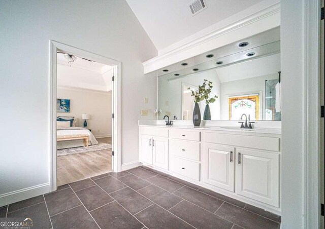 21 Whitegrass Way, Grayson, GA 30017 - bathroom featuring double vanity, connected bathroom, baseboards, lofted ceiling, and tile patterned flooring