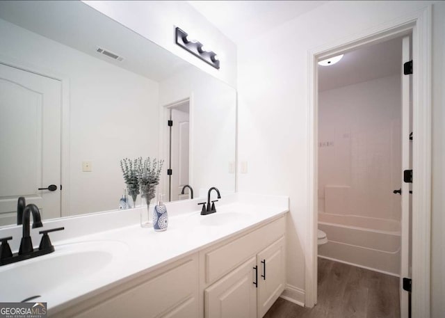 21 Whitegrass Way, Grayson, GA 30017 - full bathroom with wood finished floors, toilet, and double vanity