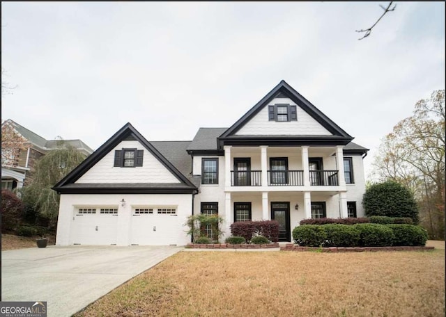 21 Whitegrass Way, Grayson, GA 30017 - greek revival inspired property with a balcony, concrete driveway, a front lawn, a garage, and stucco siding