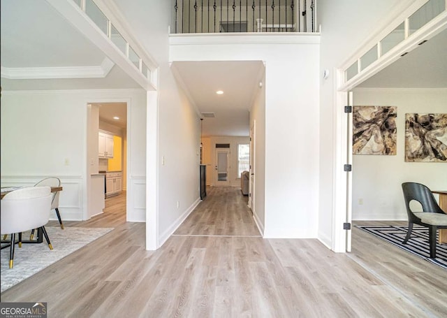 21 Whitegrass Way, Grayson, GA 30017 - foyer entrance with light wood finished floors, ornamental molding, baseboards, recessed lighting, and a towering ceiling