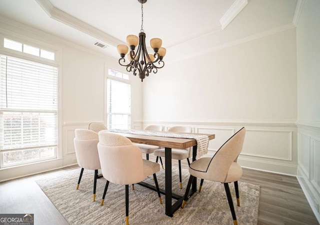 21 Whitegrass Way, Grayson, GA 30017 - dining room with a chandelier, crown molding, dark wood finished floors, healthy amount of natural light, and a decorative wall