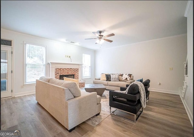 21 Whitegrass Way, Grayson, GA 30017 - living area with ornamental molding, wood finished floors, ceiling fan, baseboards, and a brick fireplace
