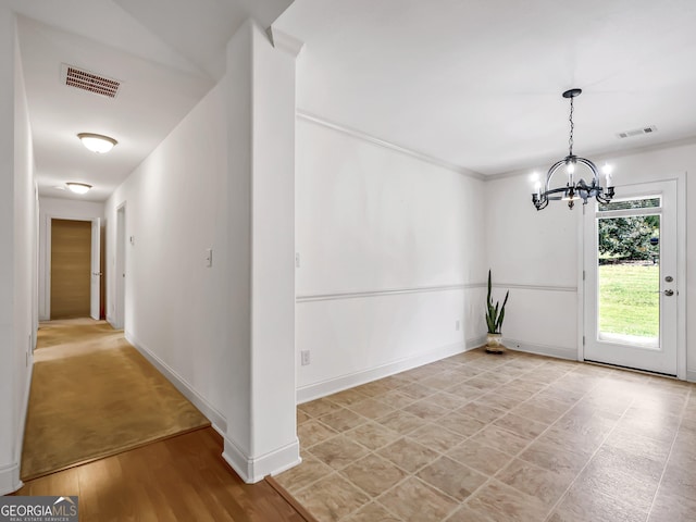 unfurnished dining area featuring a chandelier and baseboards