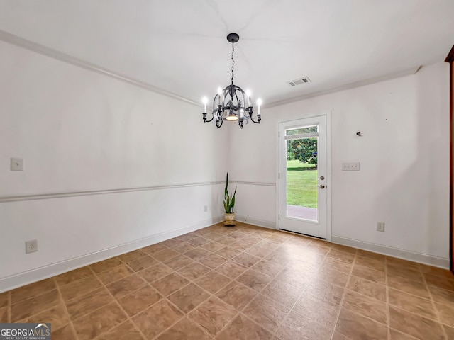 spare room with a chandelier and baseboards