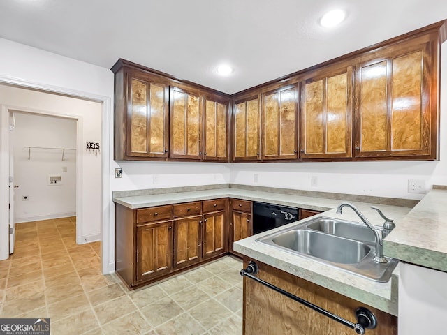 kitchen featuring black dishwasher, a sink, light countertops, and recessed lighting