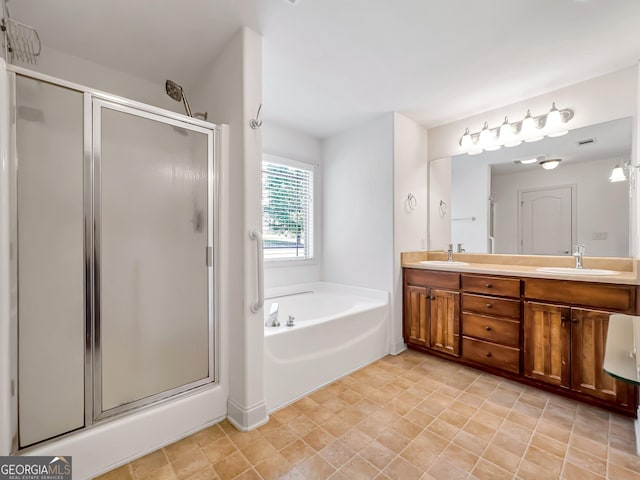 full bath featuring a shower stall, a garden tub, and double vanity