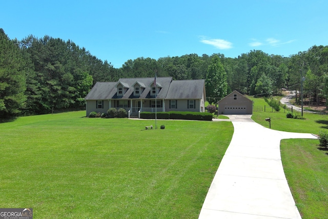 cape cod-style house with an outdoor structure, a garage, a front lawn, and a view of trees