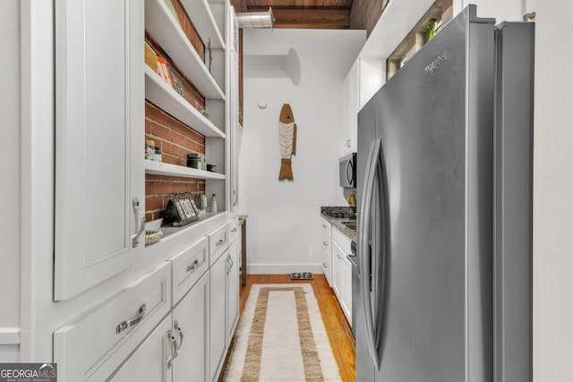 542 Ralph Mcgill Blvd Unit 7, Atlanta, GA 30312 - kitchen featuring freestanding refrigerator, white cabinetry, light wood finished floors, open shelves, and baseboards