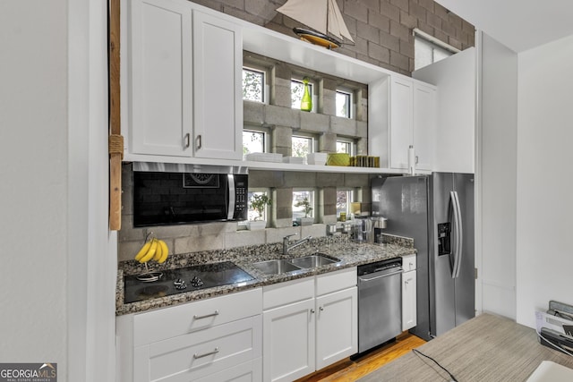 542 Ralph Mcgill Blvd Unit 7, Atlanta, GA 30312 - kitchen featuring stainless steel appliances, a sink, tasteful backsplash, dark stone countertops, and white cabinetry