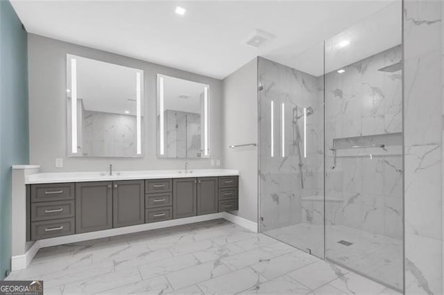 full bathroom featuring marble look tile flooring, a marble finish shower, baseboards, double vanity, and recessed lighting