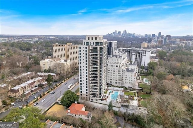 aerial view of property and surrounding area featuring nearby urban area