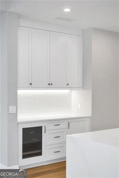 bar with recessed lighting and wood finished floors