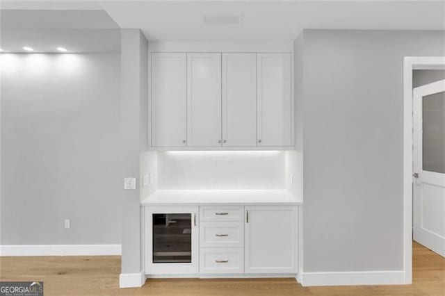 bar with light wood-style flooring and baseboards