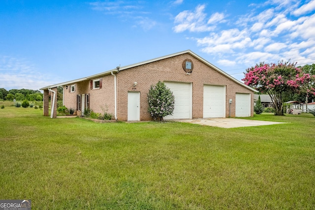 view of home's exterior with a garage, a yard, and brick siding