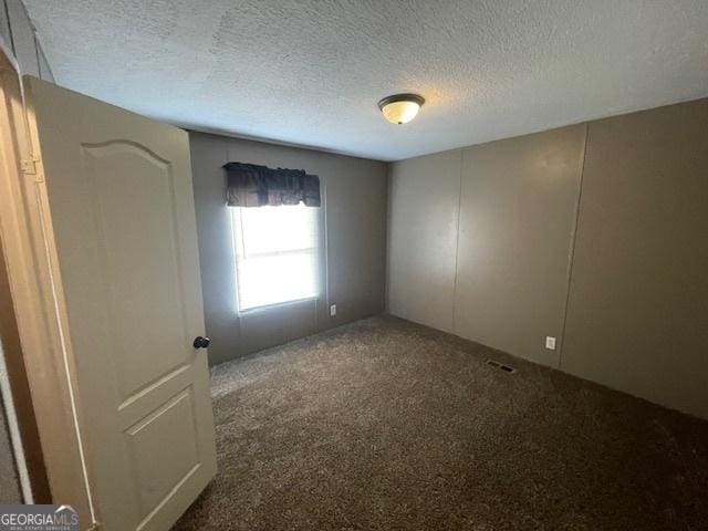 507 Jackson St, Montezuma, GA 31063 - spare room featuring carpet flooring and a textured ceiling