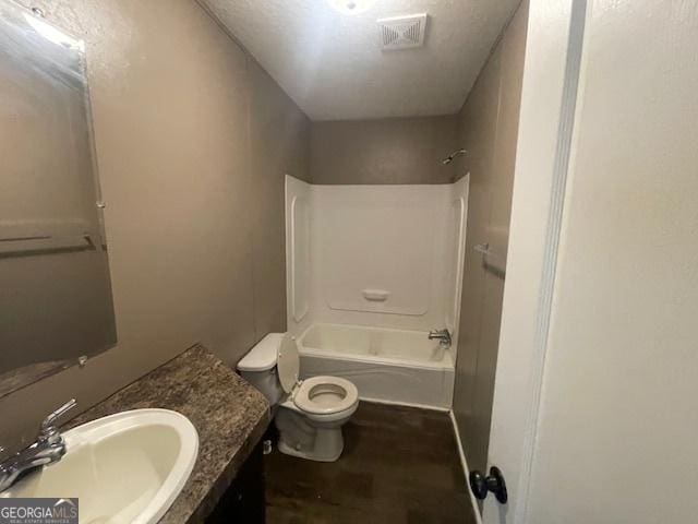 507 Jackson St, Montezuma, GA 31063 - full bathroom with toilet, wood finished floors, vanity, and washtub / shower combination
