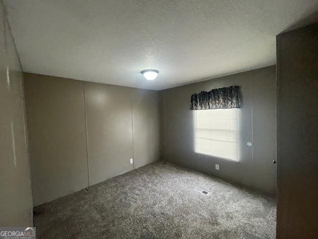 507 Jackson St, Montezuma, GA 31063 - carpeted spare room featuring a textured ceiling