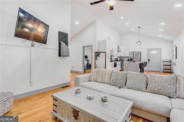 1497 Eason St NW, Atlanta, GA 30314 - living room with ceiling fan, light wood-style flooring, recessed lighting, baseboards, and high vaulted ceiling