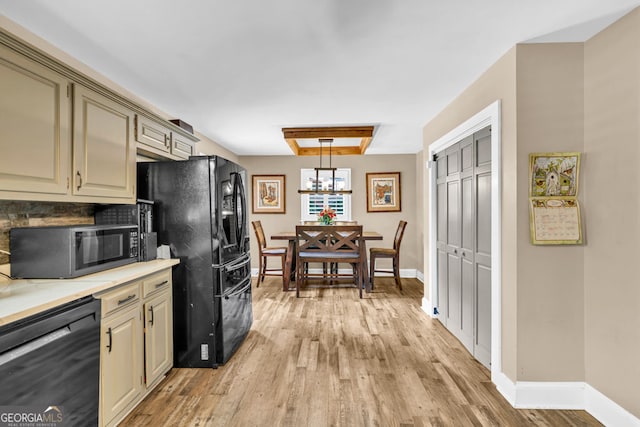 kitchen featuring black appliances, light wood-type flooring, baseboards, and light countertops