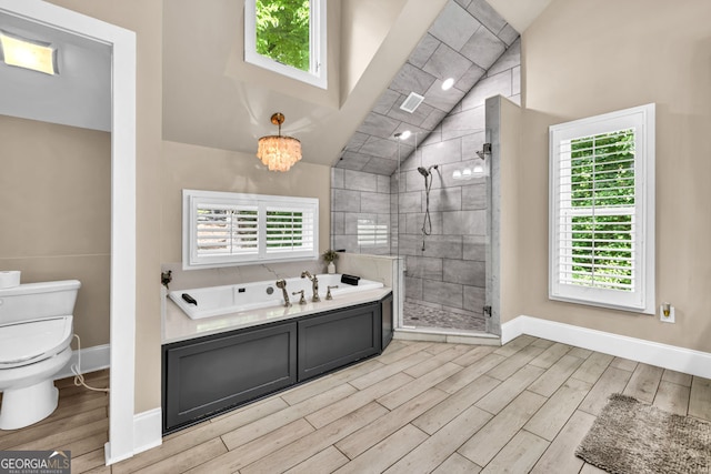 full bathroom featuring wood finished floors, lofted ceiling, a stall shower, toilet, and a garden tub