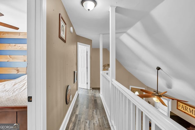 hall with wood finished floors and lofted ceiling