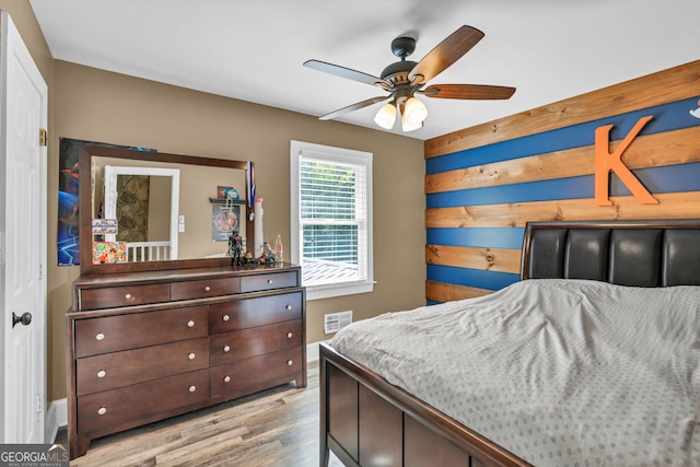 bedroom featuring light wood finished floors and ceiling fan
