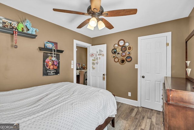 bedroom featuring wood finished floors, baseboards, and ceiling fan