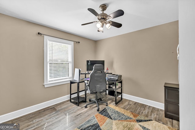 office with ceiling fan, baseboards, and wood finished floors