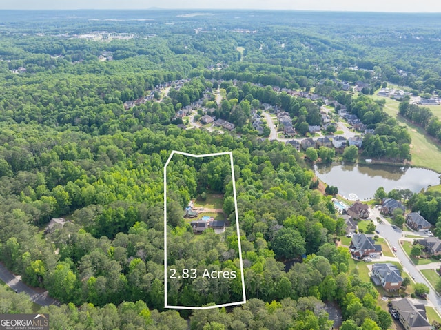view of property location with a forest, a large body of water, and property boundaries highlighted