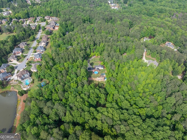 aerial view of property and surrounding area with a forest