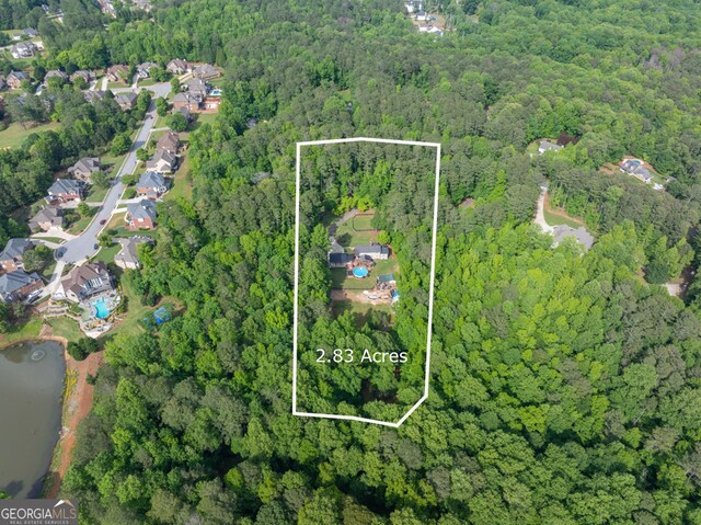 view of property location featuring a heavily wooded area and property parcel outlined