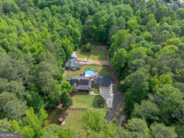 view of subject property with a forest