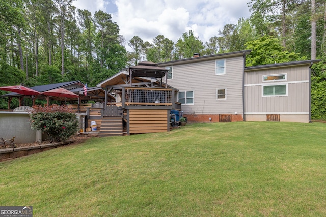 back of house with a gazebo, crawl space, a lawn, and stairway