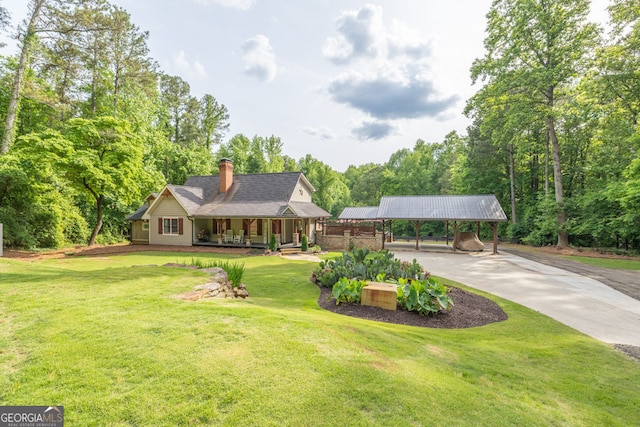 view of front of home with a detached carport, covered porch, a front yard, concrete driveway, and a chimney