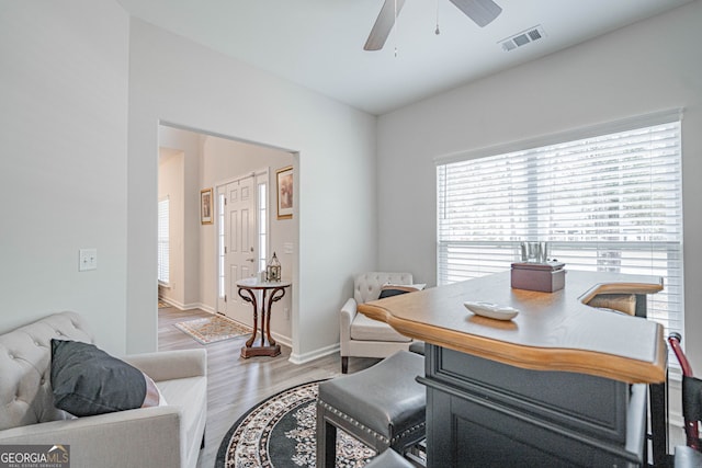 office with a ceiling fan, wood finished floors, and baseboards