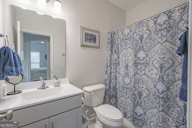 bathroom featuring toilet and vanity