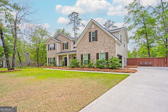 view of front of house with brick siding, driveway, and a garage