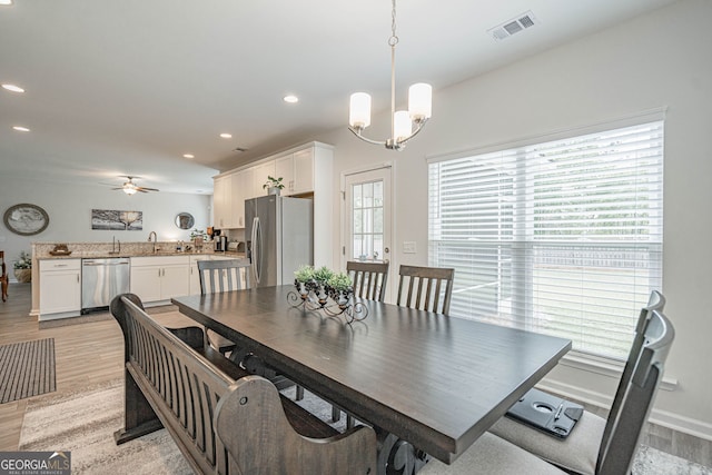 dining space with light wood-style floors, ceiling fan, recessed lighting, a chandelier, and baseboards