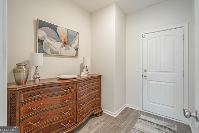 entrance foyer featuring light wood-style flooring and baseboards