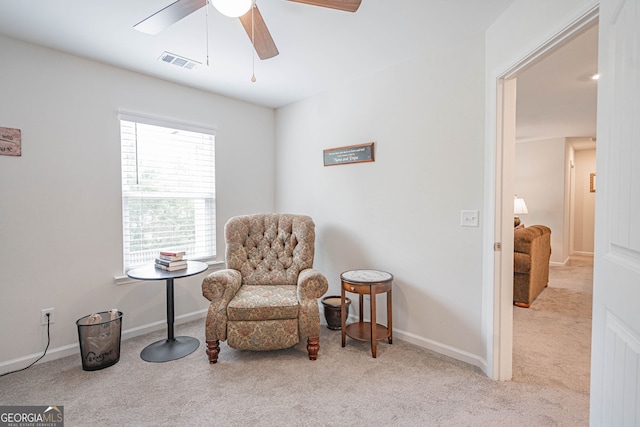 living area with carpet flooring, a ceiling fan, and baseboards