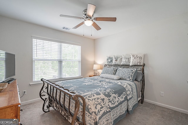 carpeted bedroom featuring baseboards and a ceiling fan