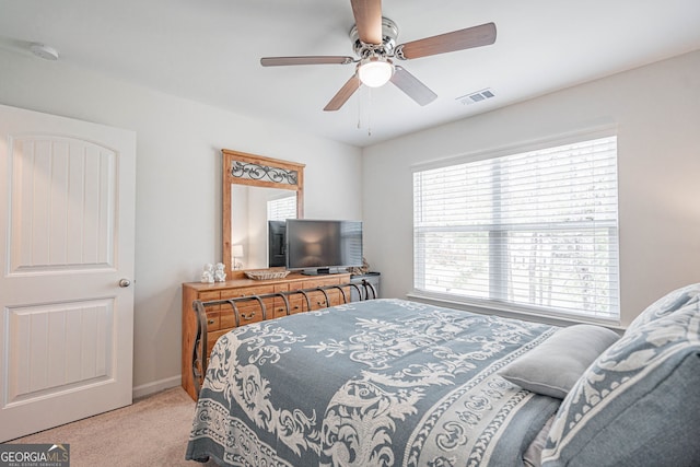 carpeted bedroom with a ceiling fan and baseboards