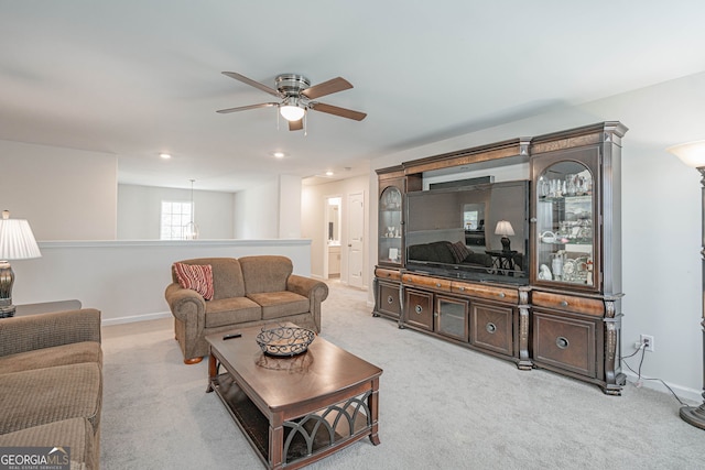 living area featuring ceiling fan, light colored carpet, baseboards, and recessed lighting