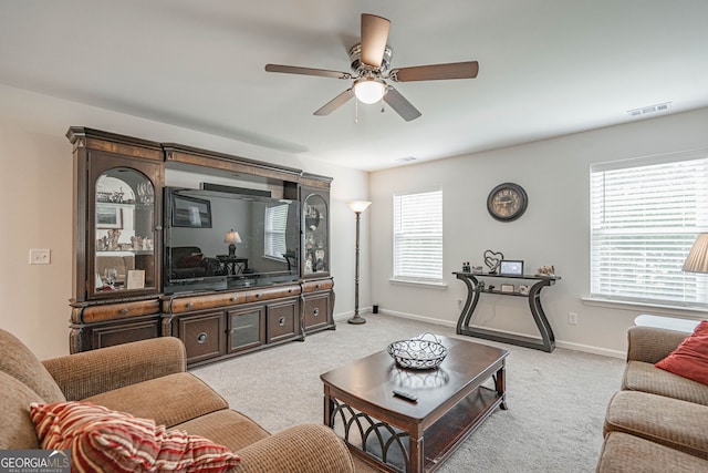living area with carpet floors, ceiling fan, and baseboards