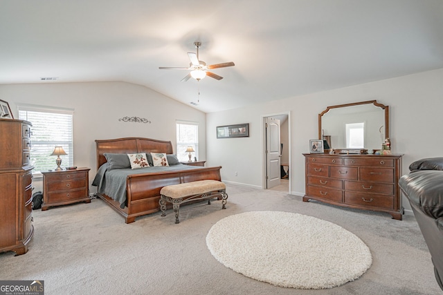 bedroom featuring light colored carpet, multiple windows, vaulted ceiling, ceiling fan, and baseboards