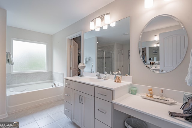 full bath with tile patterned floors, a shower stall, a garden tub, and vanity